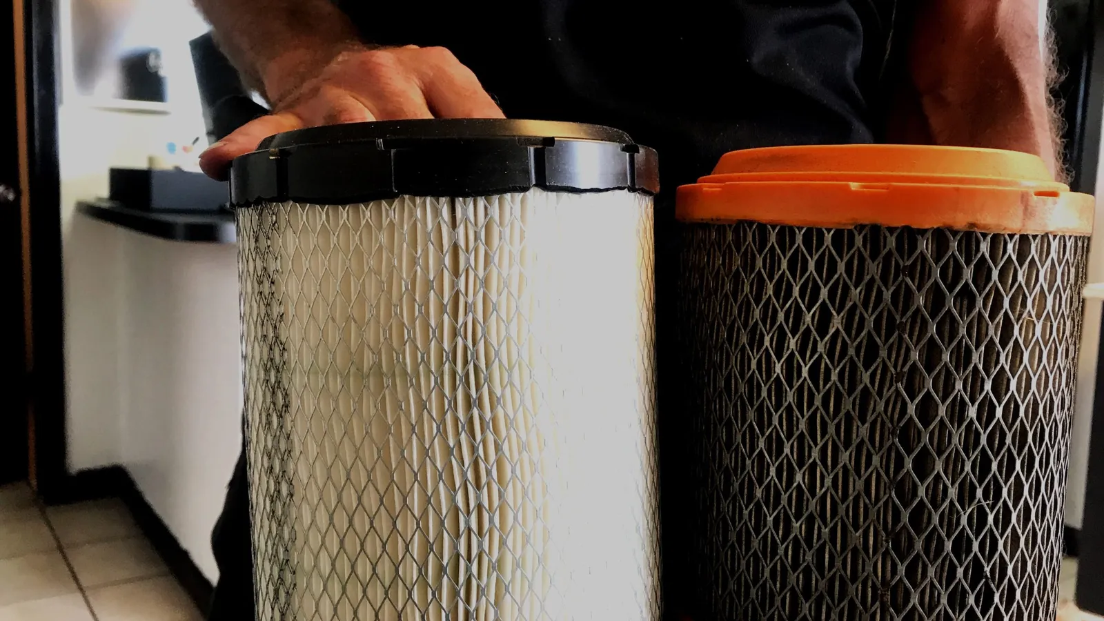 Technician fitting dust collector cartridges